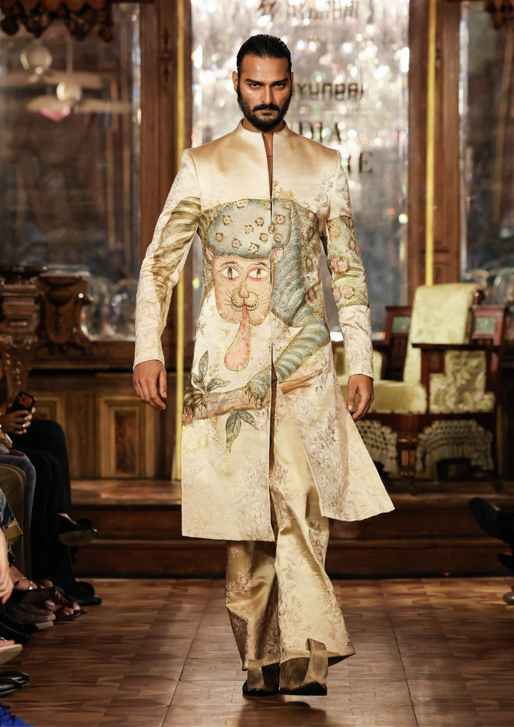 A couture coat embroidered and painted with a Kalighat-inspired animal figure and botanical forms